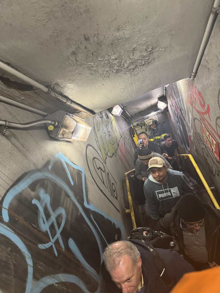 MaxSholl's tweet photo. Just evacuated an F mid station. 

Major shout out to @NYCTSubway personell for the calmness, professionalism, and instruction throughout. Shouts to @FDNY for getting  us off the train too.

Crazy walking in the tunnel and out an emergency exit to steeet level! https://t.co/YczJggMRkm