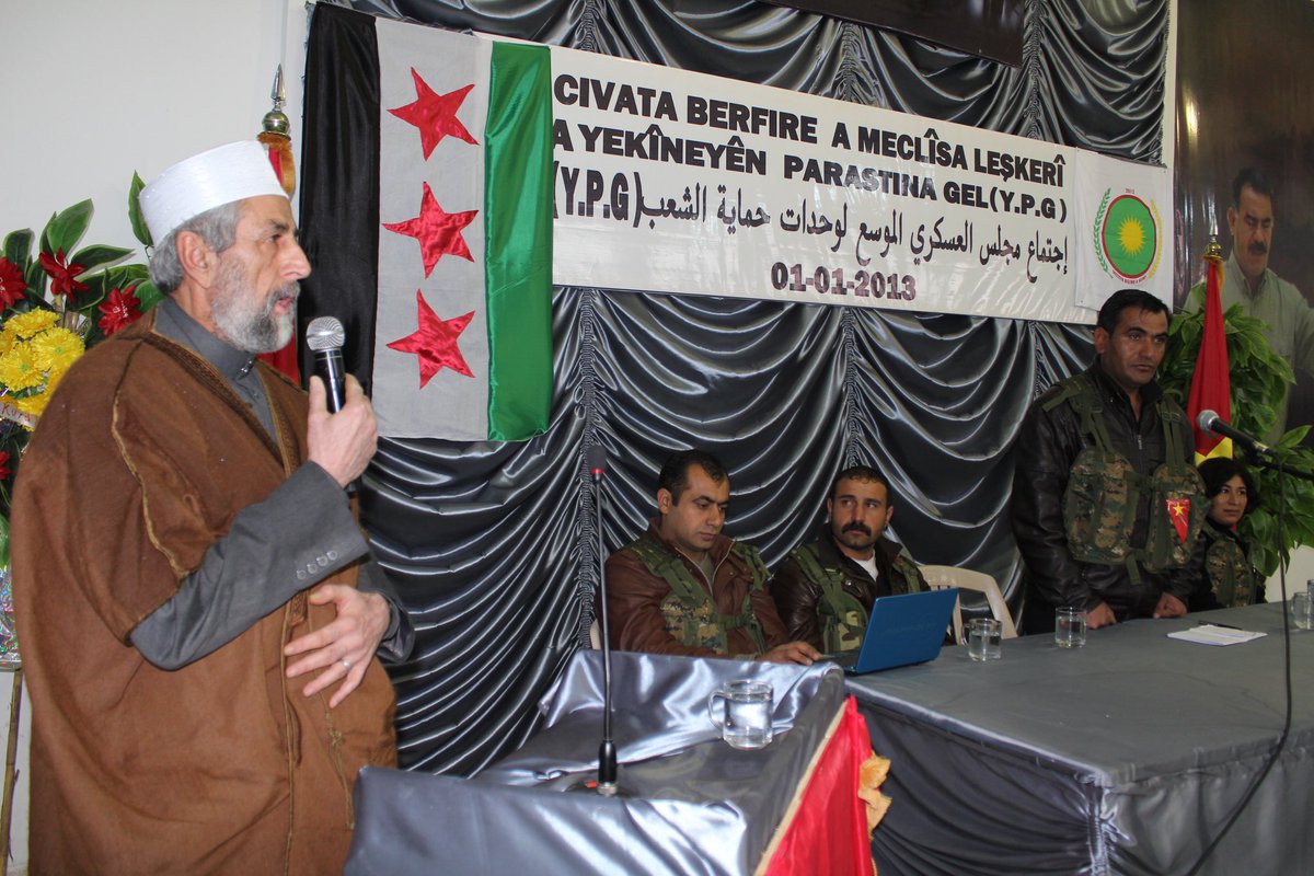 zanaamedi_'s tweet photo. 2013 - YPG’s first Military Council meeting. Note the pictures on the wall behind Mahmoud Berxwedan. https://t.co/yGh3RQifPh