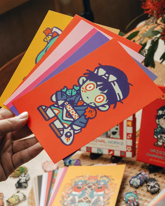 OMOCAT's original character acrylic blocks, postcard sets, button-up shirt, and omamori will be available during the OMOCAT &amp; OMORI Anniversary Exhibition and released online on 12/16 at 5PM PT. 