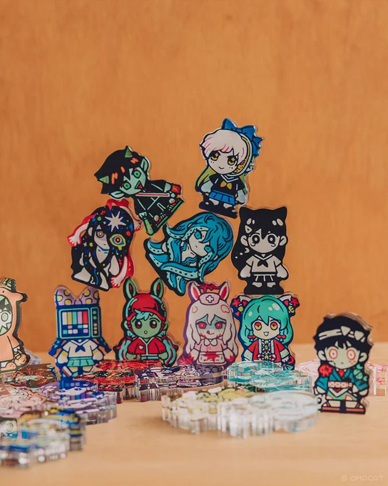 OMOCAT's original character acrylic blocks, postcard sets, button-up shirt, and omamori will be available during the OMOCAT &amp; OMORI Anniversary Exhibition and released online on 12/16 at 5PM PT. 