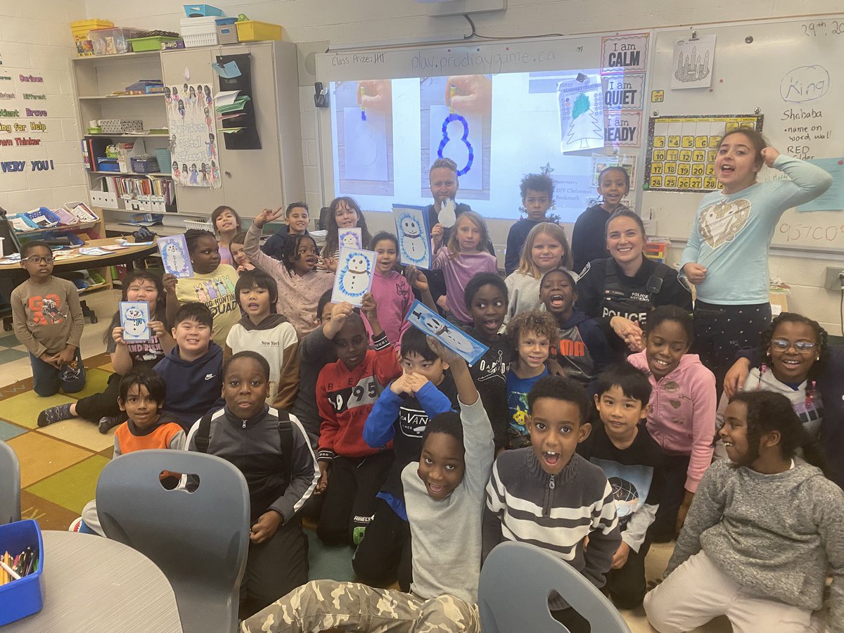 SELCook12's tweet photo. A holiday season favorite of mine! Members of the @OttawapoliceNRT popping by to hang with the kids as they make Christmas cards for our neighbors!  @MsWood26 Thanks for joining us! ♥️ Grateful for this (busy) experience! @StElizabethOCSB #ocsbCommunity @OttCatholicSB ⛄️ 🎄 🦅 https://t.co/6uelssuOpL