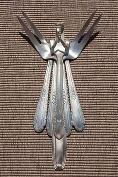 ninjaboii_art's tweet photo. @Skepta 
The arrangement of forks and knives in the image resembles an angelic figure, evoking themes of protection, transcendence, and duality. For Skepta’s Fork and Knife album, this design could embody the guardian of ambition—a figure born from the very tools of survival and hunger.