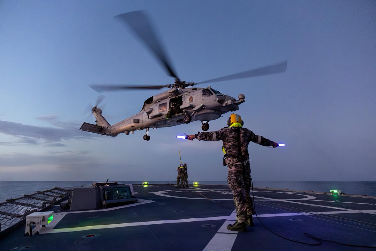 Australian_Navy's tweet photo. #OurNavy are a guiding light as MH-60R Seahawk helicopter 'Scarecrow' conducts vertical transfers for #HMASStuart regional presence deployment in the Indo-Pacific IPE24. https://t.co/9xv2erwdmn