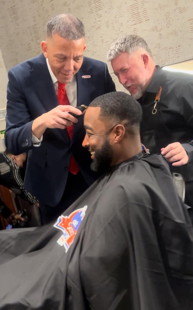 Jackson State Coach T.C Taylor getting a fresh cut for the Celebration Bowl, SWAC Commissioner Charles McClelland guest Barber