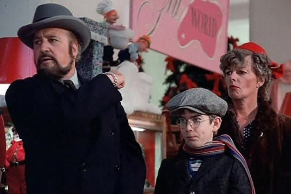 In "The Christmas Story", the man telling Ralphie where the line to see Santa at the mall ends and starts is Jean Shepherd the narrator of the movie!
