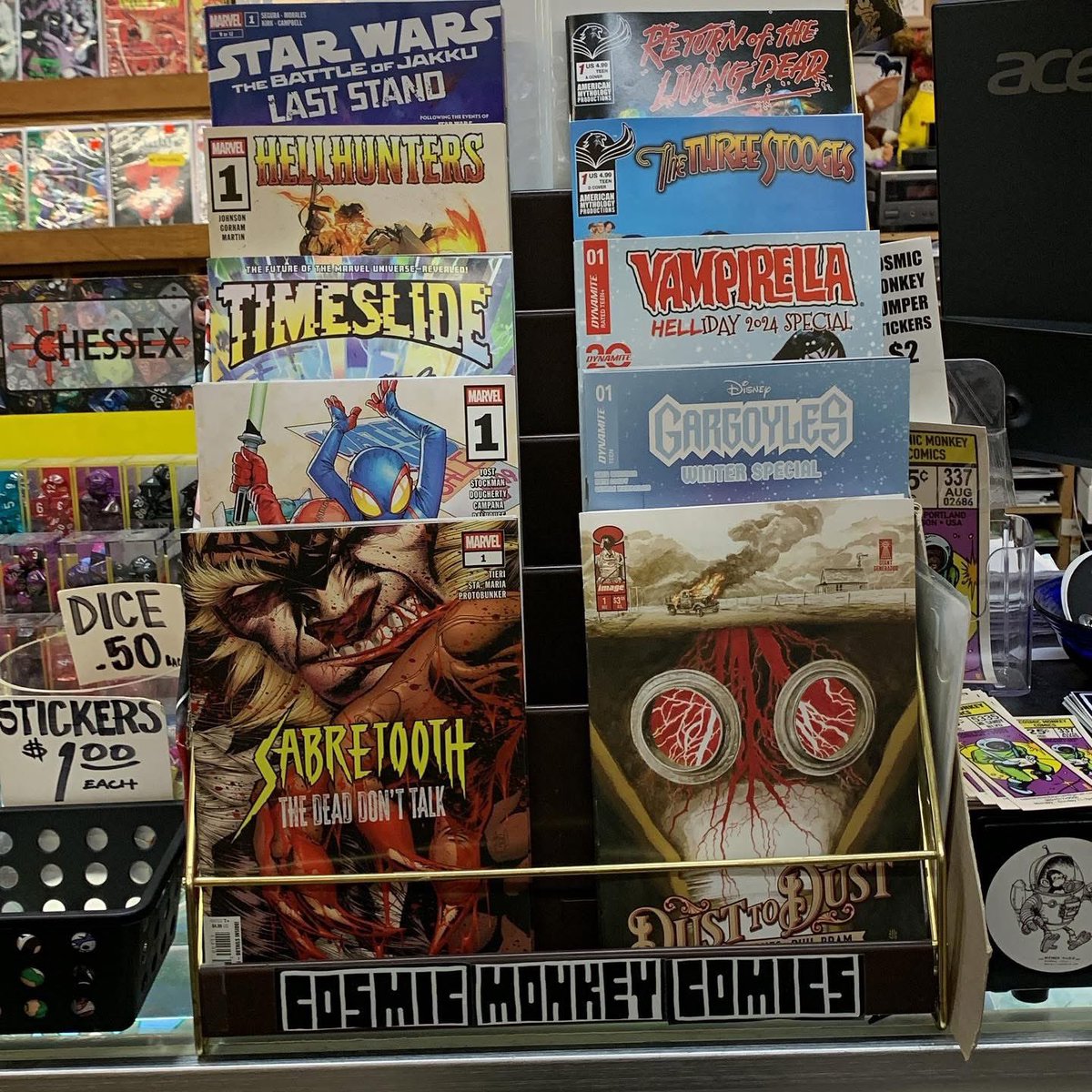 cosmicmonkey's tweet photo. Here’s an updated version of the featured rack now that orders have arrived! #sabretooththedeaddonttalk #dusttodust #kidpoolspiderboy #gargoyleswinterspecial #timeslide #vampirellahelliday2024special #hellhunters #thethreestoogesnewyearsnitwits #starwarsbattleofjakkulaststand https://t.co/ce7WZhmaiL