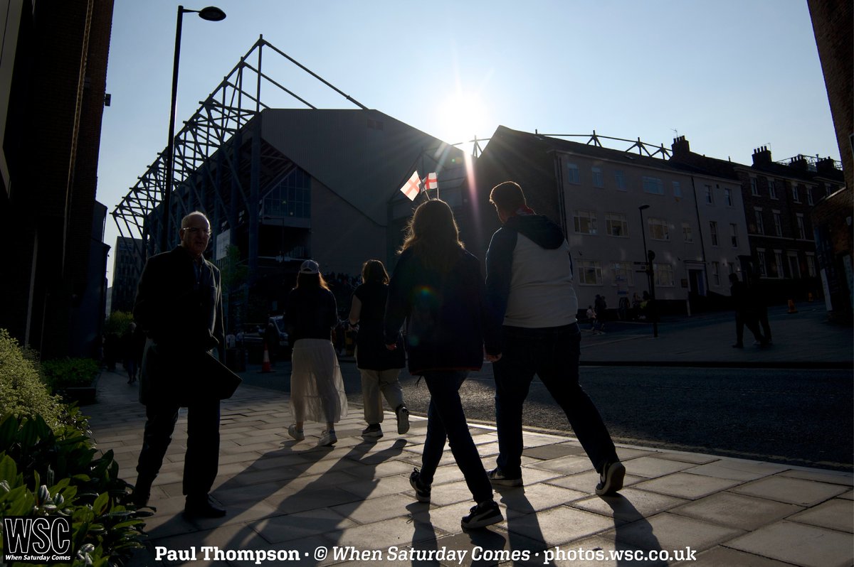 "Newcastle was a happy city in the late May sunshine. I found this viewpoint with a patch of pavement illuminated against the silhouette of St James' Park. A couple of <a href="/Lionesses/">Lionesses</a> fans walked past, one wearing head bopper things, which for a second or two were perfectly backlit"