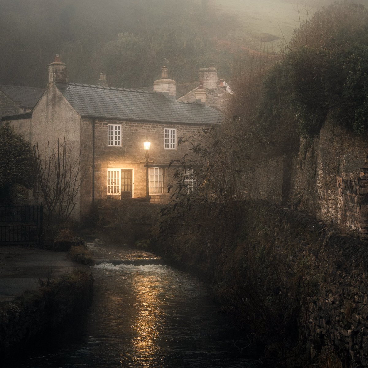 peaklass1's tweet photo. In the deep of winter these little cottages in Castleton seem to hunker down and huddle together beneath the misty hills, and the lamplight shines through the longest nights to beckon you safely in out of the dark. #peakdistrict https://t.co/Dh27hi0cqN