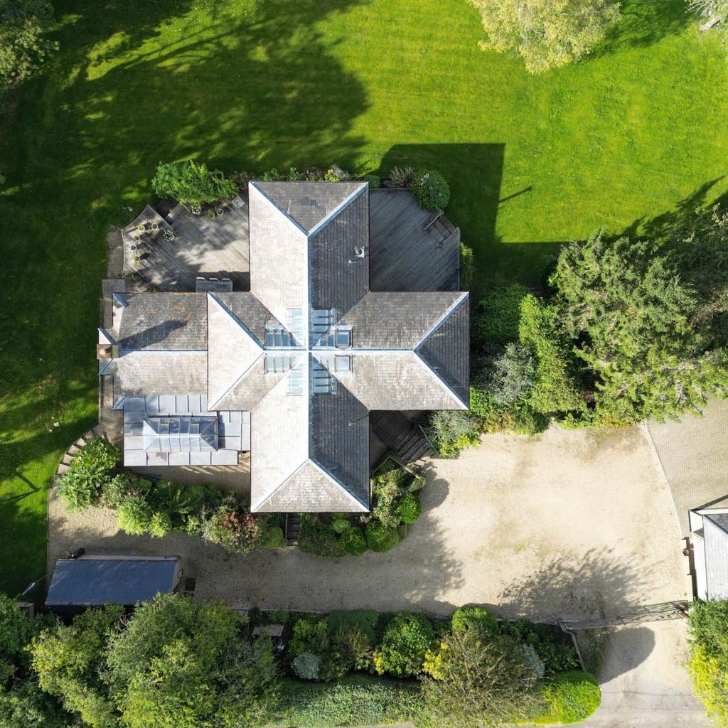 Featured on Channel 4’s Grand Designs, this home’s unique cross-shaped layout centers around an octagonal kitchen—an open-plan space perfect for socialising. A soaring void connects the kitchen to the galleried first-floor landing, crowned by a striking glazed roof lantern.