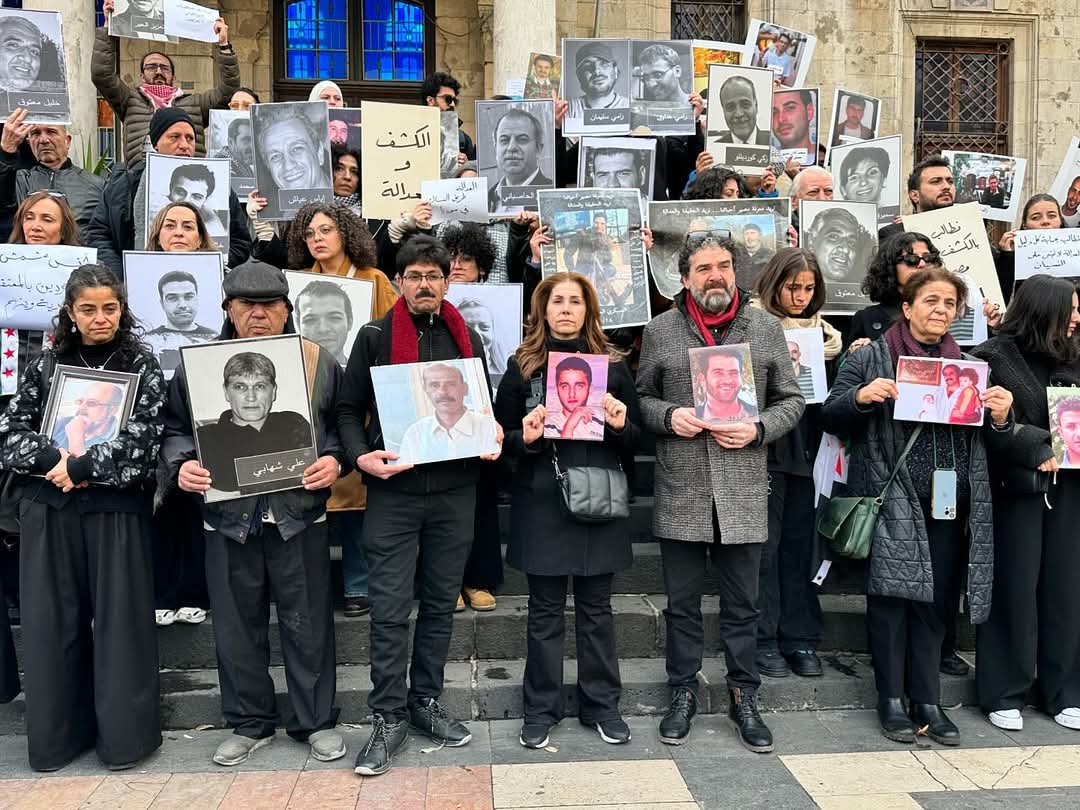 HamadiShady's tweet photo. Yesterday in #Damascus, a silent demonstration held infront of alHijaz Station by the families of prisoners that are still missing, despite all prisons had been liberated. Over 112000 are the missing Syrians. #themFirst. #Syria https://t.co/htlQ9vzOFM