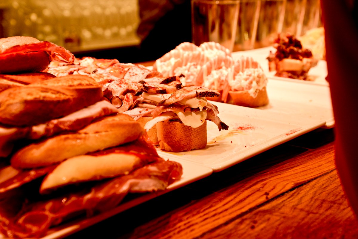 VisitBasqueCtry's tweet photo. "Poteo" 🥂 means going from bar to bar with your friends and it's one of the most typical customs in the Basque Country. Take a look at this route to try the best pintxos in #Bilbao's Old Town.
🗺️https://t.co/TdpcbRxY9J
#VisitBasqueCountry https://t.co/hTcjfJ1C3i