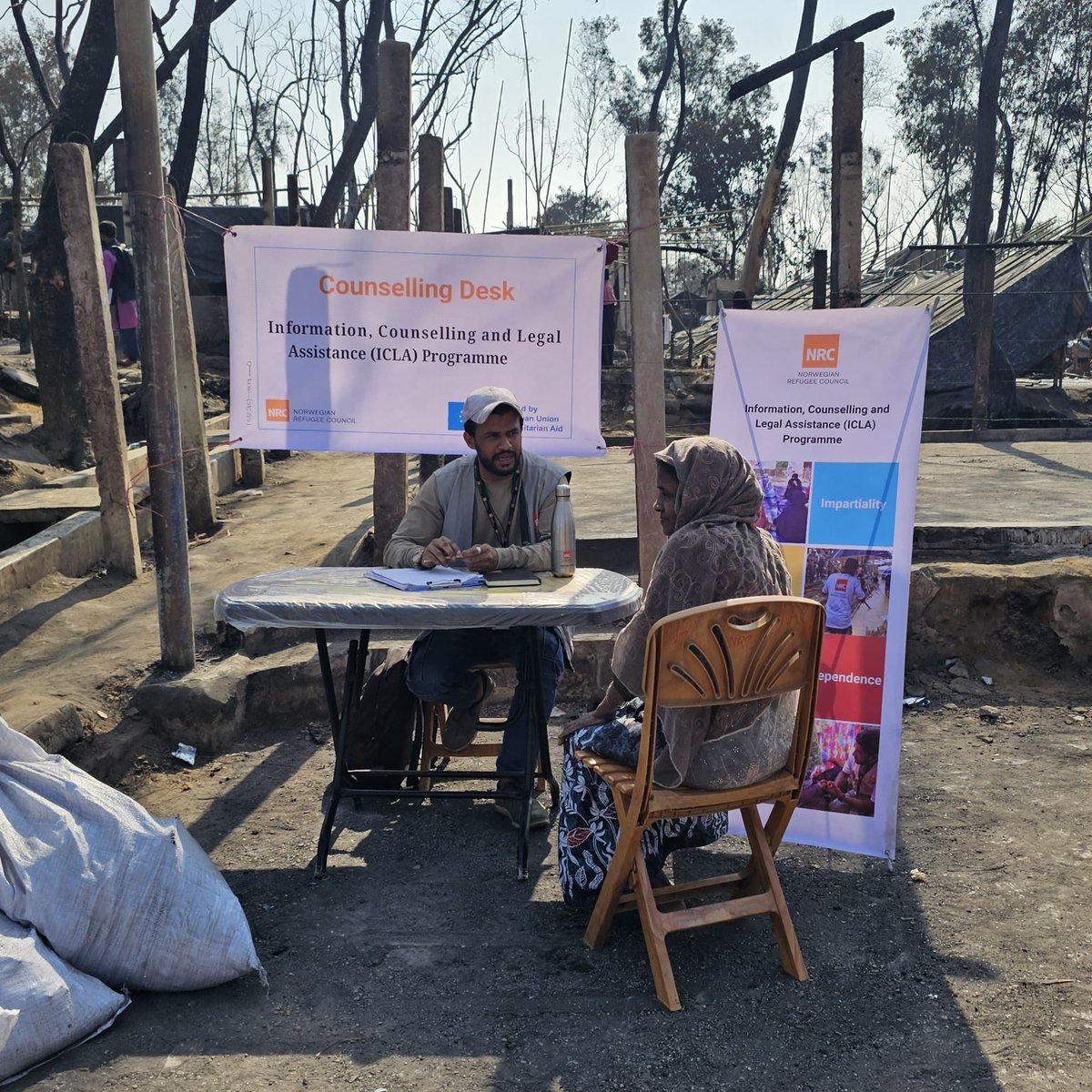 NRCBangladesh's tweet photo. As part of the Camp 1W #fire response @NRC_Norway 🇧🇩 legal counselling team set up help desks to offer free legal support &amp; help recover crucial lost documents. #Safe durable shelters are required more than ever to prevent further losses to life &amp; belongings. Pic: @SahatZia_Hero https://t.co/rOwXFHhbQF