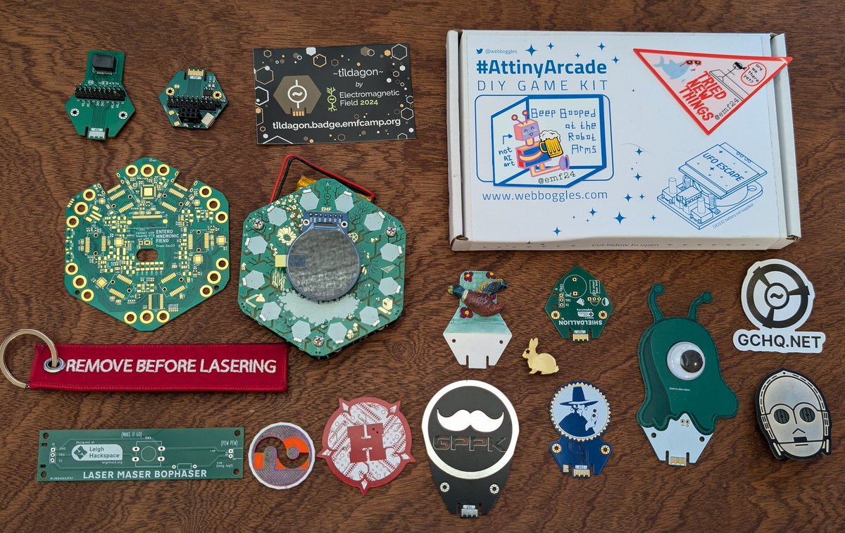 A (very) late pic of our <a href="/emfcamp/">Electromagnetic Field</a> 2024 loot! A lot of really cool stuff from awesome people~