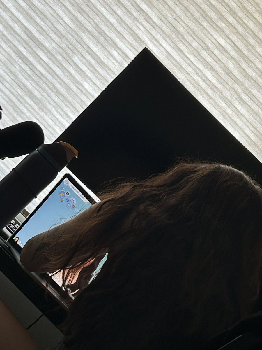 There’s a half naked man in the bed and she’s playing the sims