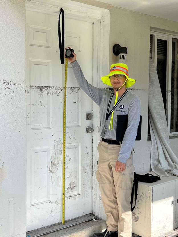 a person holding a measuring tape on a white door