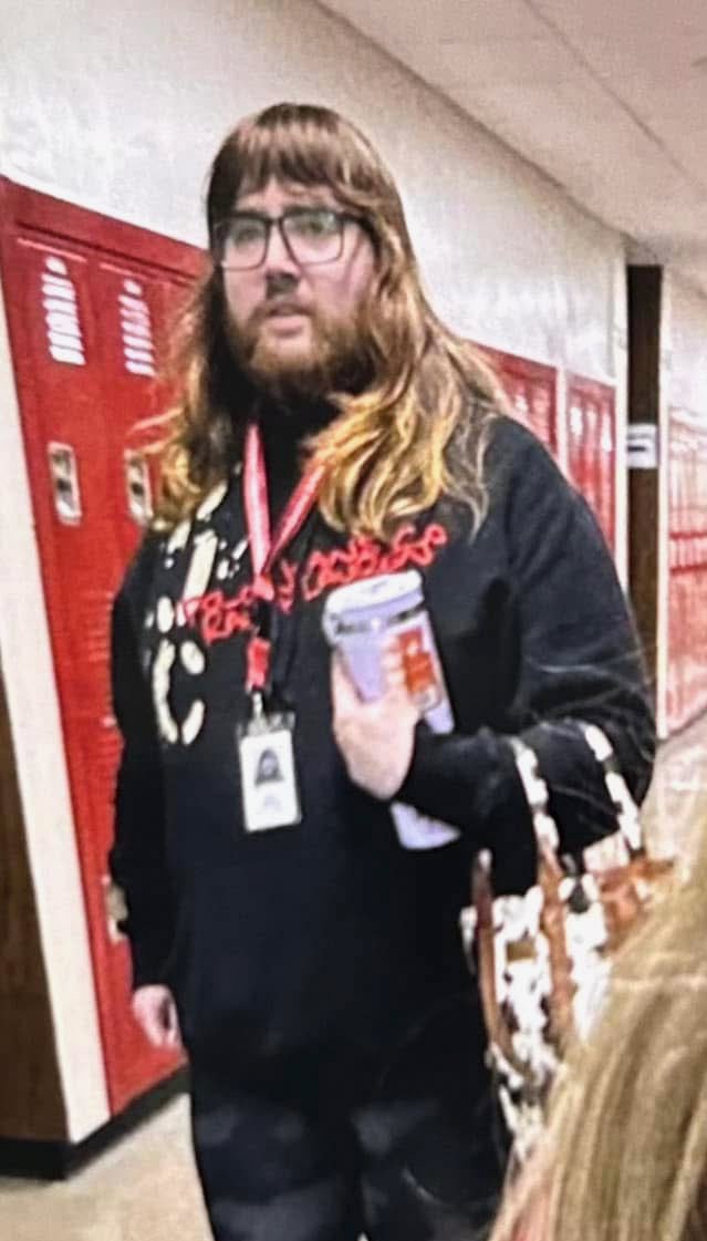libsoftiktok's tweet photo. New York teacher who posted a threatening image with a gun also reportedly crossdresses and wears wigs to teach.

Image this person teaching your kids https://t.co/vOicRrSzuq