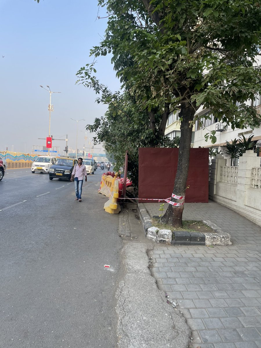 Ashwin7611's tweet photo. BMC just swallowed our footpath at the iconic marine drive. pedestrians must walk to road to be hit by a speeding car. location. Shreeniketan building on Marine drive. BMC pls remove immediately. https://t.co/YSI0bD292J