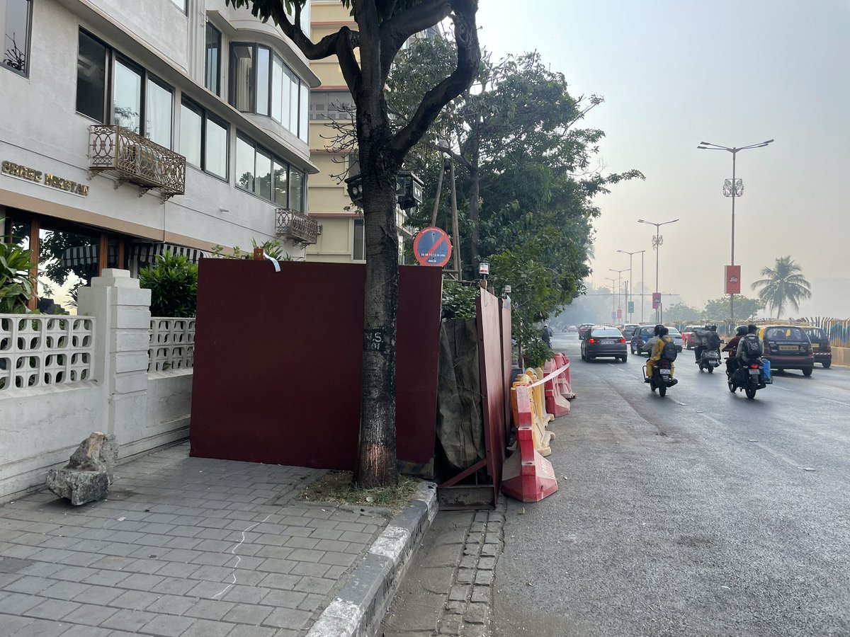 Ashwin7611's tweet photo. BMC just swallowed our footpath at the iconic marine drive. pedestrians must walk to road to be hit by a speeding car. location. Shreeniketan building on Marine drive. BMC pls remove immediately. https://t.co/YSI0bD292J