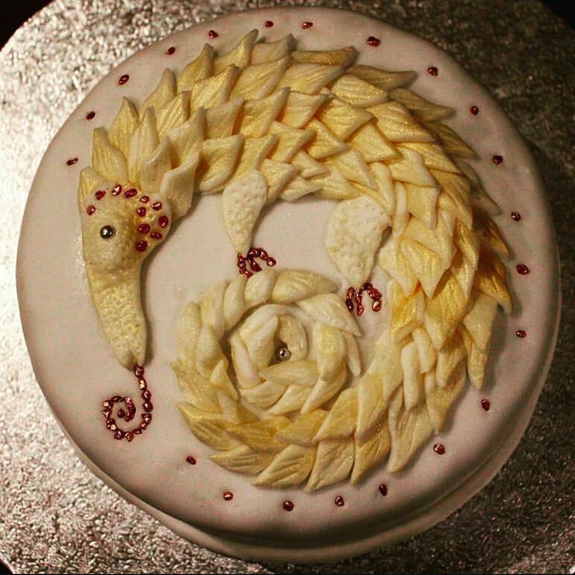the_manticore_'s tweet photo. The number of cake eaters in my life has declined to such a small number that I’ve entirely stopped baking. But I’ve been reminiscing about some of the fantastical royal icing creatures I’ve made at this time of year. Because a Christmas pangolin is usual bill of fare- right? https://t.co/SCSxP0WXRy