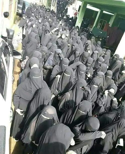 ImtiazMadmood's tweet photo. How will a Muslim man recognize his wife in such a burqa-clad crowd?

1. By smell/stench
2. Shouting her name
3. Call on her mobile phone
4. By her ankle/shoes
5. GPS implant
6. She will recognize him
7. Use the method of differentiating 72 virgins
8. Choose the wrong one by consent
9. Guess with associated risks
10. Beat them one by one till a familiar scream
11. Apple air tag
12. Hold up a sign with her name
13. By the coloured ribbon tied to her niqab like the airport luggage