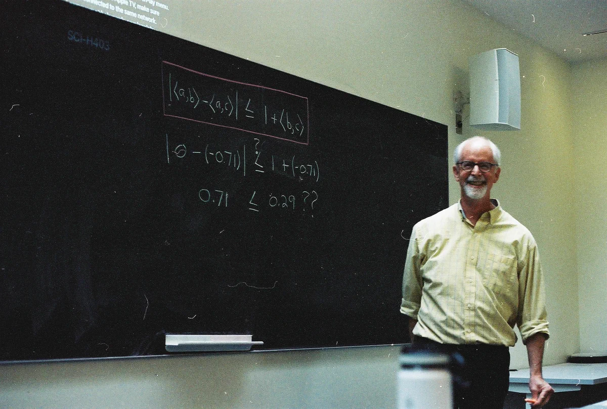 Prof. Glenn Stark in front of a blackboard