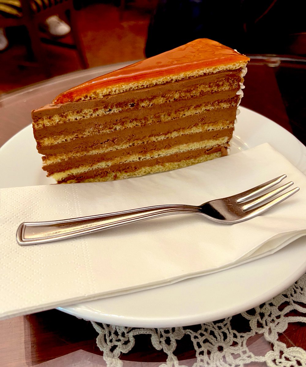 simongreening's tweet photo. Then on to Buda Castle and of course there’s time for a stop at a cukrászda that’s been going strong for 197 years for a slice of #Dobos & a coffee (doily optional)! #Budabest 🇭🇺 https://t.co/Zyj8YWttWw