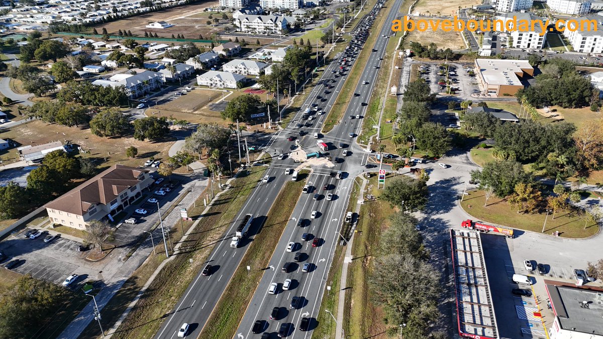 AboveBoundary's tweet photo. Captured the aftermath of a dump truck accident at the intersection of US 27 and Polo Park East Blvd in Four Corners, FL. The truck tipped over, spilling dirt across the highway and causing significant traffic delays.  #AerialPhotography  #FourCornersFL https://t.co/ZK1ek7UcqN