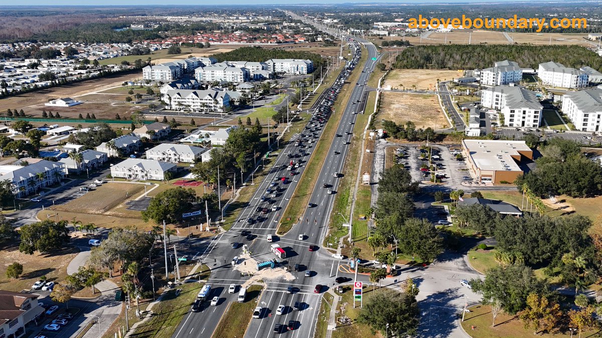 AboveBoundary's tweet photo. Captured the aftermath of a dump truck accident at the intersection of US 27 and Polo Park East Blvd in Four Corners, FL. The truck tipped over, spilling dirt across the highway and causing significant traffic delays.  #AerialPhotography  #FourCornersFL https://t.co/ZK1ek7UcqN