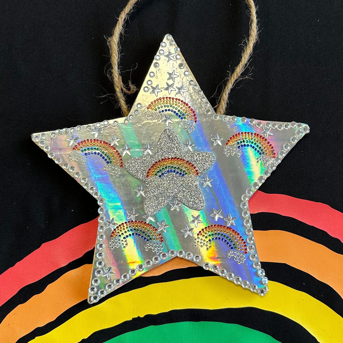 Shining at the top of the tree is Felicity's shiny, silver, tactile Christmas star! She took a lot of care adding details to make her star tactile and accessible, and we love that it's covered in tactile VICTA rainbows. Well done!

#TreeForTreats