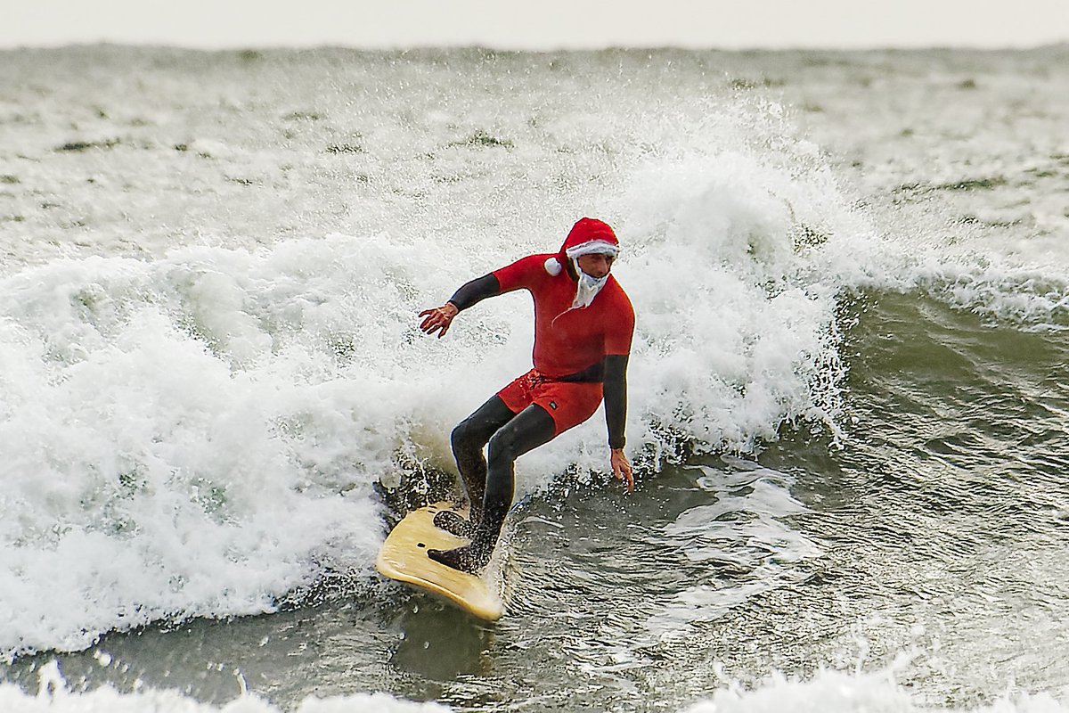 Dozens of people of all ages took part in the 2024 #SantaDip #LanglandBay, near #Swansea, Wales, UK athena-pictures.com #santasurf #santadip #langlandbay #surfing #waves #santaclaus #festive #christmas #xmas #surfboard