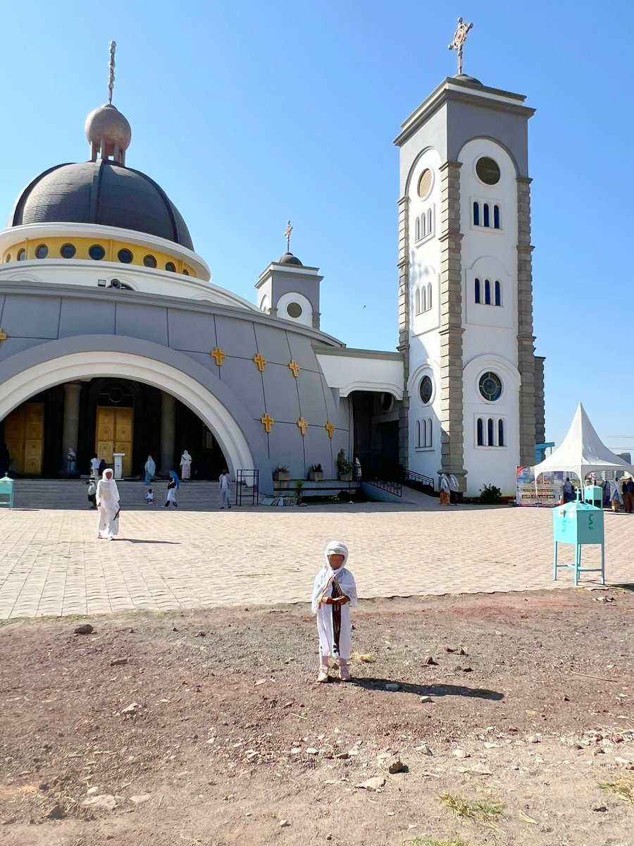 renoomokri's tweet photo. Orthodox Christianity Is Closer To Islam Than European Christianity 

This is my daughter at the Ethiopian Orthodox Tewahedo Church on the Sabbath Day, which, for those who may wish to know, is from sunset on Friday to sunset on Saturday (this was taken this Saturday). That is my wife in the background. We are currently in Ethiopia to celebrate the Orthodox holiday of Timket. 

Notice how they are dressed? They are covered from head to toe. This is how Orthodox Habesha (the real name for Ethiopia) Christian women have been dressing to go to church for almost two thousand years since Aksum (the pre-Christian kingdom of Abyssinia) became a Christian nation. 

Christianity in Ethiopia began after the Ethiopian eunuch of Acts Chapter 8 was converted by Phillip and returned home to Abyssinia with the message of the Gospel. 

Notice that this church looks like a mosque. Why? The Habesha people have been building churches like this for almost two thousand years. Even before prophet Muhammad, Sallallahu Alayhi Wasalaam, was born.

They also have priests who call out worship similarly to how Islamic muezzin call the Mu'min to prayer.

When prophet Muhammad, Sallallahu Alayhi Wasalaam, had his encounter with the angel, one of those he sought guidance from was Waraqah ibn Nawfal, a Christian priest, who was aware of the Christian kingdom of Abyssinia in Aksum.

And so, when the Quraysh or Mecca wanted to kill the first Muslim converts and companions of the prophet, called the Sahabah, the prophet urged them to seek refuge in Aksum with Ethiopian Orthodox Tewahedo.

That was the first Hijrah in Islam, not the Hijrah Medina. The Hijrah to Medina was in 622 CE, and the Hijrah to Aksum was in 615 CE.

When the Quraysh sent emissaries to the Negus (king) of Aksum, asking him to surrender the Mu'min to them, the Negus refused and said that the Mu'min were like Ethiopian Orthodox Tewahedo Christians. According to the Negus, the only difference is that the Mu'min believe Yeshua (Jesus) is a prophet, while Tewahedo Christians believe He is the Son of God. 

According to the Negus, all other differences between Tewahedo Christians and Islam were trifles. 

The Negus gave the Mu'min a town called Harar as a refuge city, and from that time till today, Harar, in Ethiopia, is the fourth holiest city in Islam. 

The name by which the Ethiopian Orthodox Church is called, Tewahedo, has exactly the same meaning as the central article of faith in Islam, Tawhid. 

Tewahedo means 'united as one'. Tawhid means 'making one'. Both of them proclaim that there is only One God. 

Prophet Muhammad’s (SAW) nurse and nanny, Umm Ayman, was an Ethiopian. She was present on the day the prophet of Islam was born and on the day he died. 

Ruqayyah, the daughter of prophet Muhammad (SAW), lived in Ethiopia for ten years with her husband, Uthman, the third Caliph of Islam.

Men and women enter an Orthodox Church from different entrances and do not mingle within the building. They seat in separate places. And they do not set apart Sunday for worship services. Every day is a service day. 

Before you argue, the Ethiopian Orthodox Tewahedo Church has the oldest compete and illustrated New Testament in the world. 

Please do not get it twisted. The Dead Sea Scrolls are the oldest Tanakh (Old Testament) in existence. The Codex Sinaiticus is the oldest text of the Christian Bible, but it is not illustrated. 

However, the Garima Gospels are the oldest complete and illustrated New Testament (Matthew, Mark, Luke, and John) on Earth. 

So, please stop seeing Muslims as enemies. This happens when you blindly follow the pseudo-Christianity that came from Europe rather than the older Orthodox Christianity. 

Your real enemy is not the other religion. You foe is ignorance. Read. Iqra. Once you conquer ignorance, your eyes will open, and you will begin to realise that the difference among all Abrahamic faiths is just like the difference between British, American and Canadian English.
