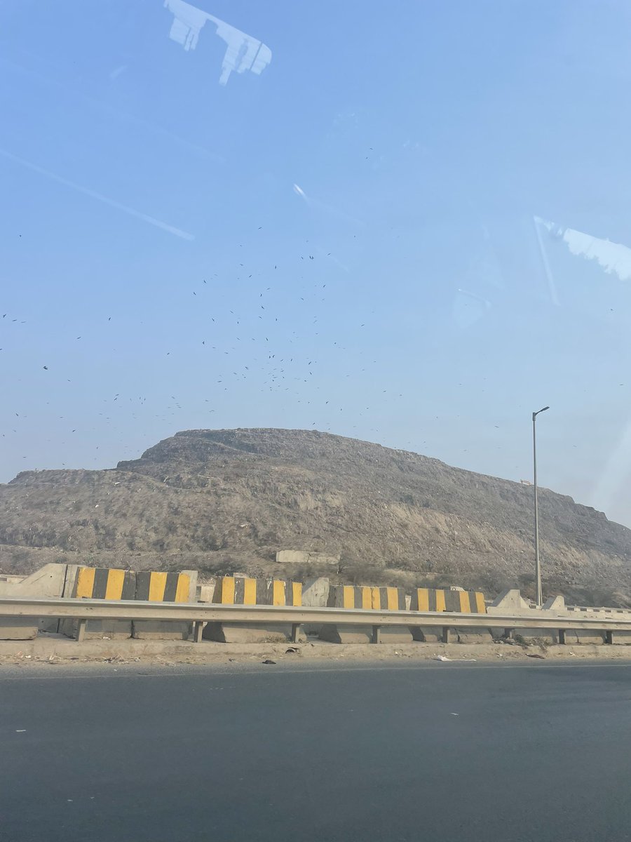 iamVikas97's tweet photo. This mountain of trash is formed by layers &amp; layers of plastic bags filled with all kinds of mixed waste paper, cans, food and putrid stinking matter from the kitchens of homes, like yours and mine and waste from offices and industries – nothing but ‘pure’, undiluted MCD waste https://t.co/vb7v3eQ5zM