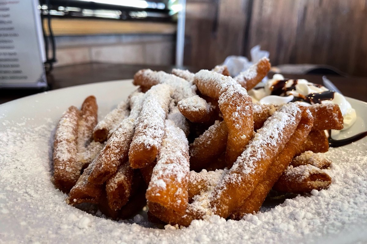 Donald_G_Redman's tweet photo. Beignet “sticks” - a play on traditional beignets. Yummy!
Alphabet Challenge. #WeekYforYummy
Since about the 16th century, beignets have been eaten during Mardi Gras by the French. A beignet is a French-style fried square doughnut.
How did it become an iconic New Orleans dessert?
Introduced in Louisiana by French founders of New Orleans and the French Acadians in the 18th century. (The Acadians - Cajuns - were French Canadians who were forced into exile from Nova Scotia by the British, many of whom settled in southwest Louisiana)
Beignets are commonly served hot with powdered sugar for breakfast or as a dessert. They are made by deep-frying choux pastry dough, which puffs up when cooked. The word beignet loosely translates to “fritter” in English.
The beignet has been described as being similar to funnel cakes and fritters, but not as sweet as a doughnut.
I compare it to Native American/Spanish inspired sopapillas.
In 1862, the iconic New Orleans restaurant, Café du Monde, opened and sold the modern beignet, forever marrying the two. To this day, Café du Monde sells beignets around the clock, all days of the week — and it's the only item the business serves, other than its famous coffee with chicory and hot chocolate.