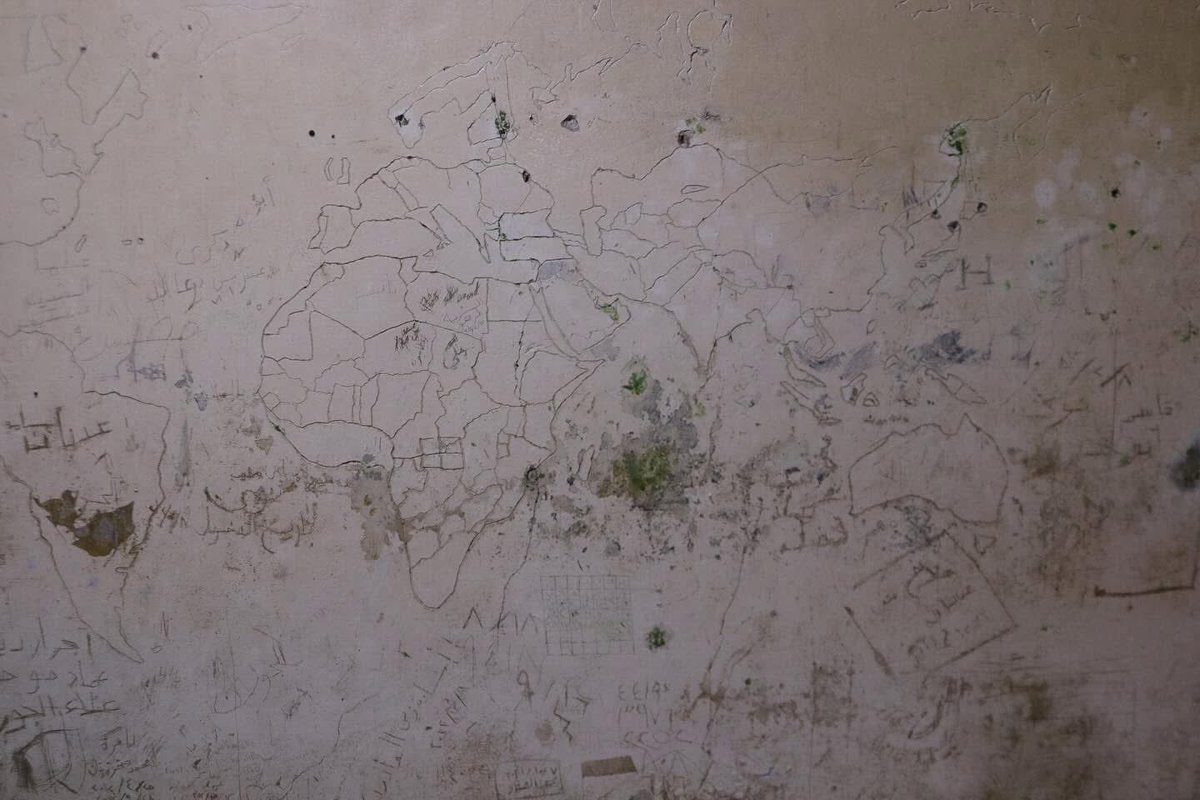 A map of the world carved by a detainee on the wall of a cell in Branch 248, one of Syria’s torture prisons.