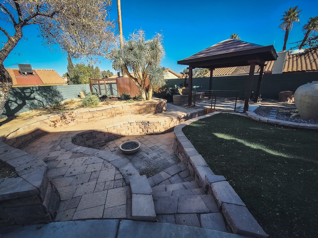 More pics of the HUGE yard! Has a  fire pit, dog run or chicken coop, vineyard area, fireplace. Great for entertaining! View of The Strat from the primary bedroom!