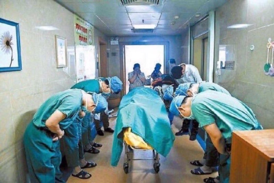 Doctors bowing to 11 year old boy with brain cancer who saved lives by donating his organs.