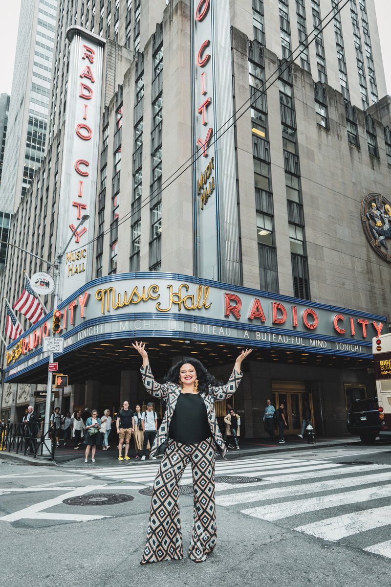 netflix's tweet photo. The first woman to film a comedy special at Radio City Music Hall…talk to her nice! Michelle Buteau: A Buteau-ful Mind premieres December 31! | 📷: The Tyler Twins https://t.co/1l6qoiJRCU
