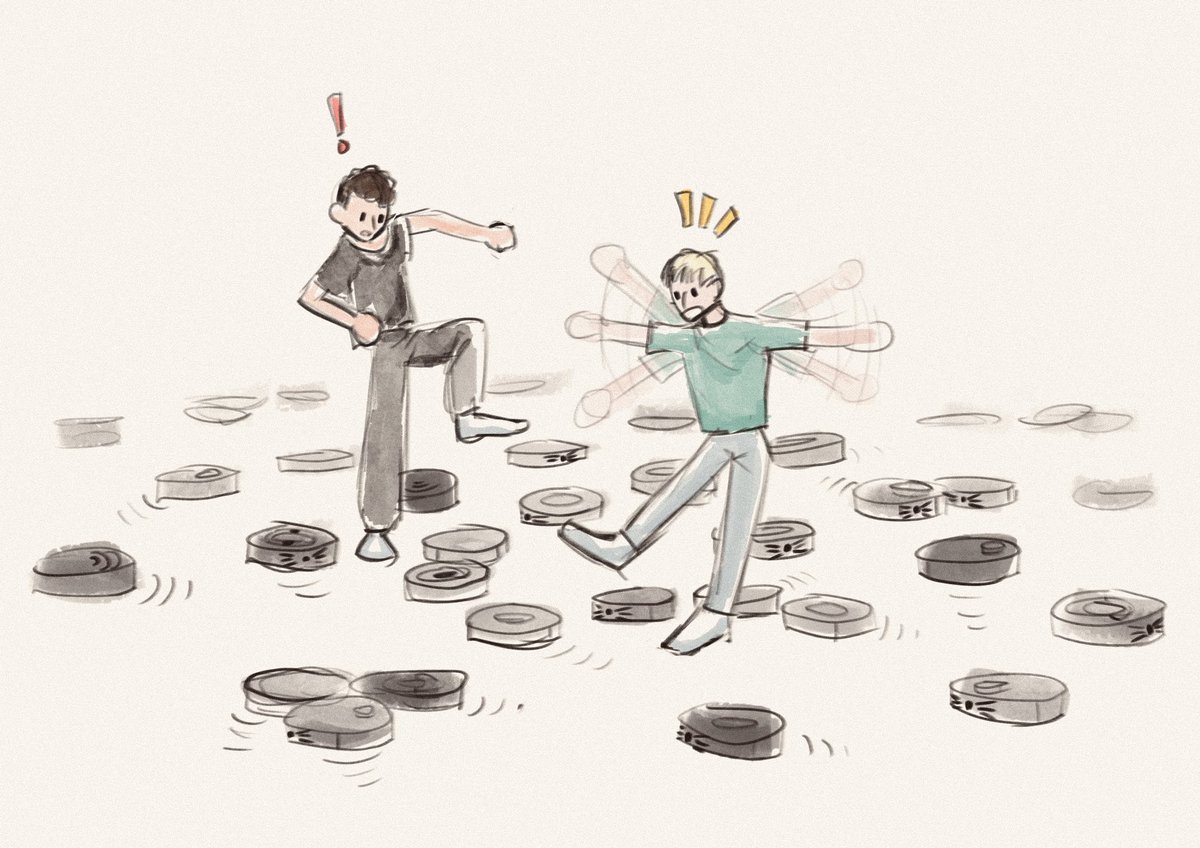 dan and phil in a room full of roombas. they are everywhere. dan and phil are precariously trying to step over them, phil is losing his balance.