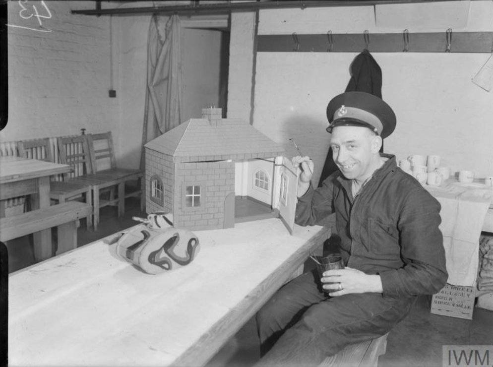 🎄Around Christmas, Marines and Naval Ratings spent time making toys from scrap wood.

Pictured here is Marine J W Miller of Newton Heath, Manchester, with a "home-made" doll's house and tank, 1943. 

📸 © IWM A 20606
#christmas #warhistory