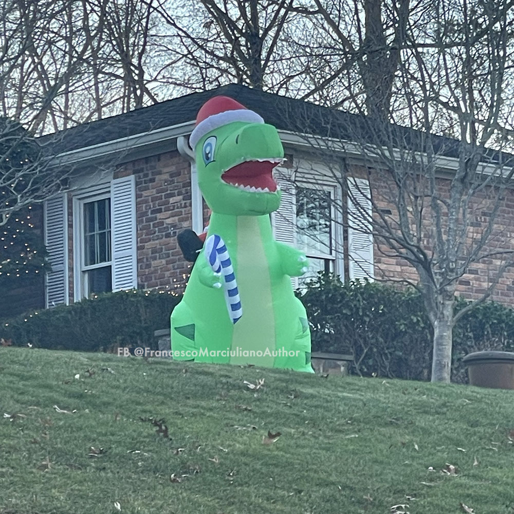 Neighbor's display a nod to that forgotten Rankin/Bass holiday cartoon "Christmas Dinosaur Saves Christmas with Misfit Christmas Powers and Also There's an Evil Wizard or Warlock or Something and Maybe We've Made Too Many of These Specials."