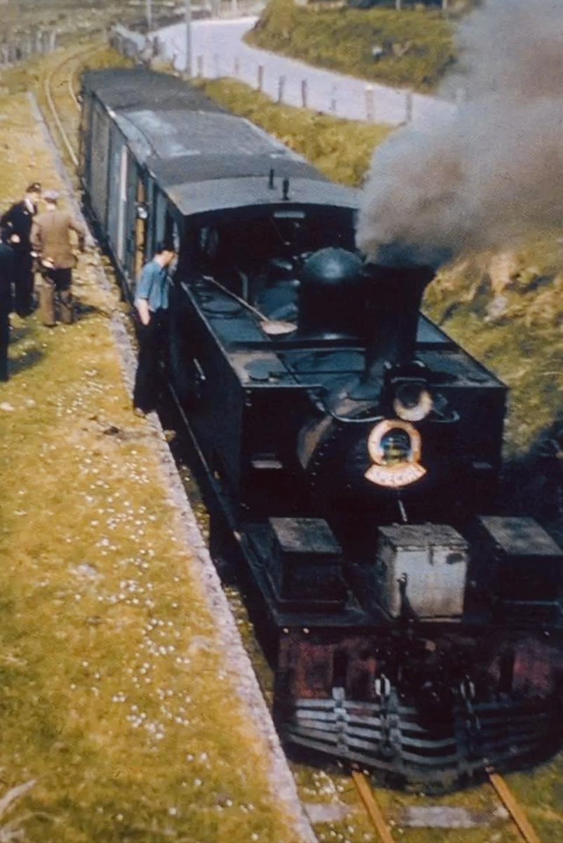 Having scaled the 680ft Glenagalt Pass, Hunslet 2-6-0T 8T rests with the LRTL tour as its members mill about the abandoned platform of the titular station. These stops, &amp; taking on water at Castlegregory &amp; Annascaul, meant that it would take 3 1/4hr to reach Dingle - 45min late.