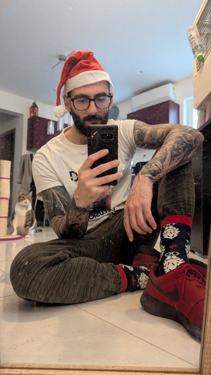 Christmas socks on 🧦 

Green trousers and red shoes to match the theme

Oracle on the background looking at me like what the hell am I doing? 😺 

Merry Christmas ⛄ and happy holidays from Damaged &amp; Co.