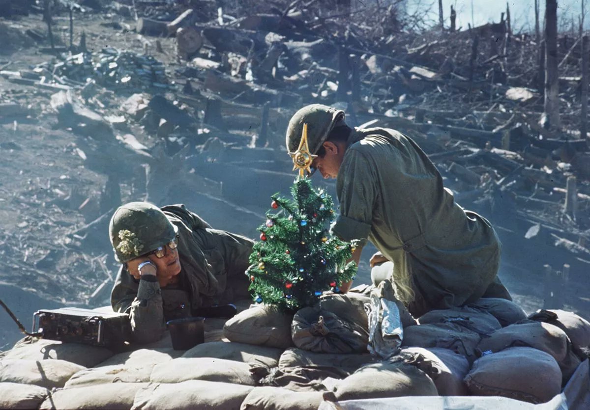 American soldiers rest near a small Christmas tree on Hill 875 following the intense Battle of Dak To in South Vietnam, December 25, 1967. #MerryChristmas2024