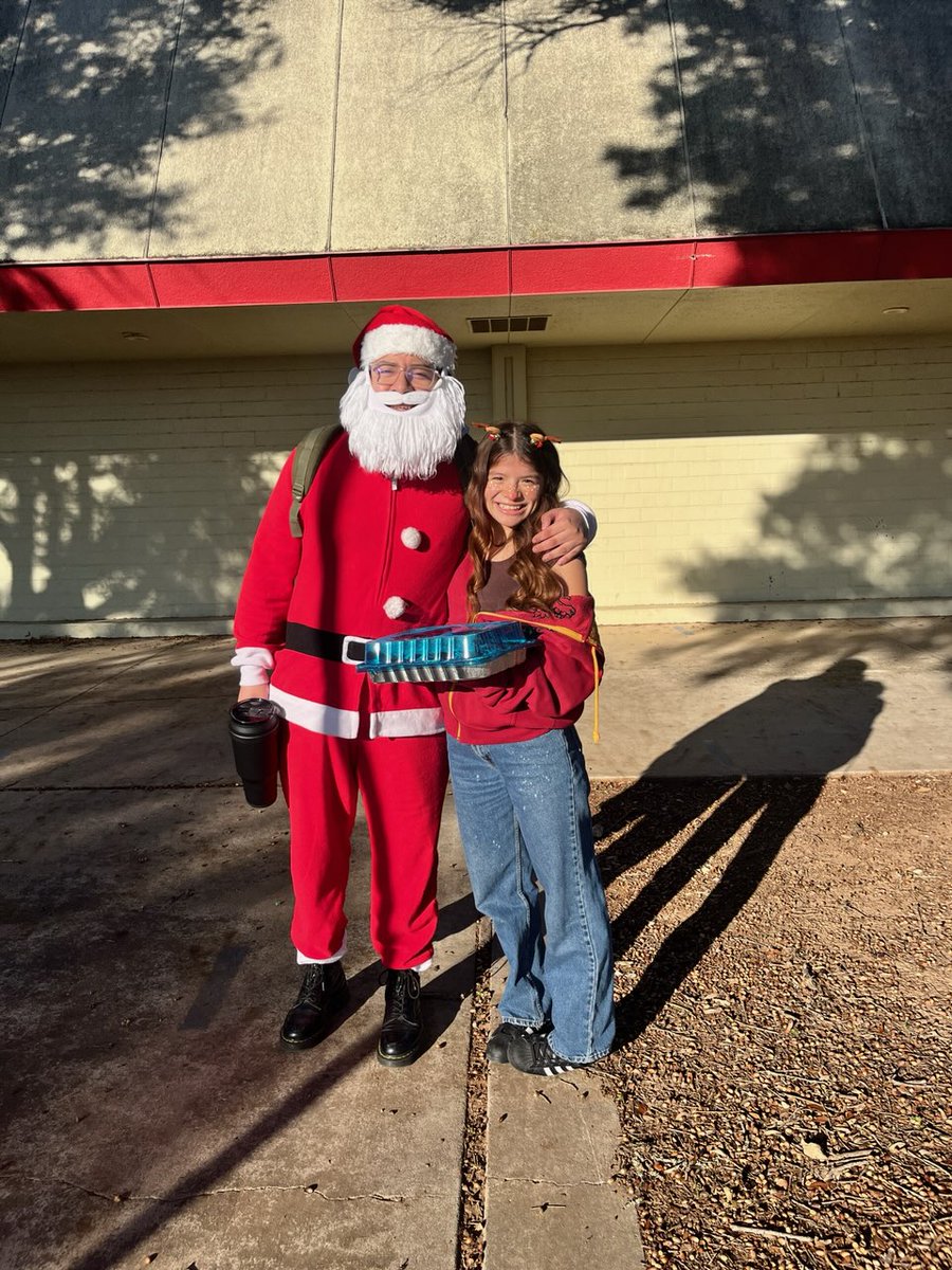 Santa suits + student success = College Possible magic! 🎅✨ One of our AmeriCorps coaches brought the holiday spirit to campus, showing that mentorship can be festive and impactful. 🎄💡 #AmeriCorps #MentorshipMatters #HolidayCheer #CollegePossible