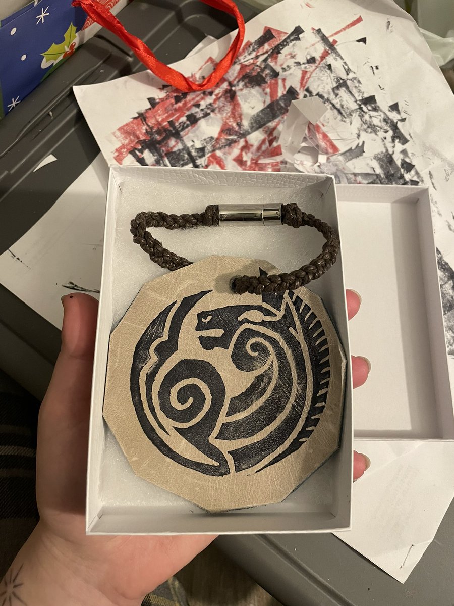 flo0ty's tweet photo. The gift I made for my dad
lino print stamp I carved and stamped onto some leather and made into a bag accessory, but he's just wearing it as a bracelet 😅 https://t.co/XUjXDkEGJC