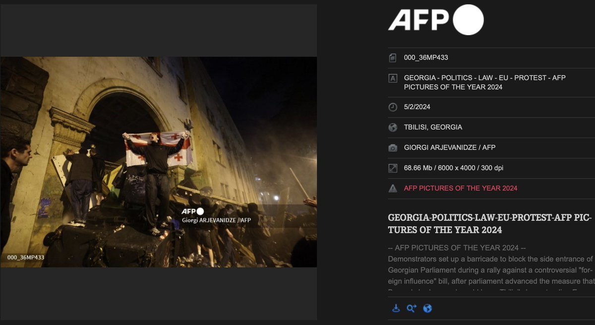 My photo is one of the AFP Pictures of 2024 . Demonstrators set up barricades to block the inside entrance of Georgian Parliament in Tbilisi on may 1,2024. Giorgi Arjevanidze/AFP <a href="/AFPphoto/">AFP Photo</a>
