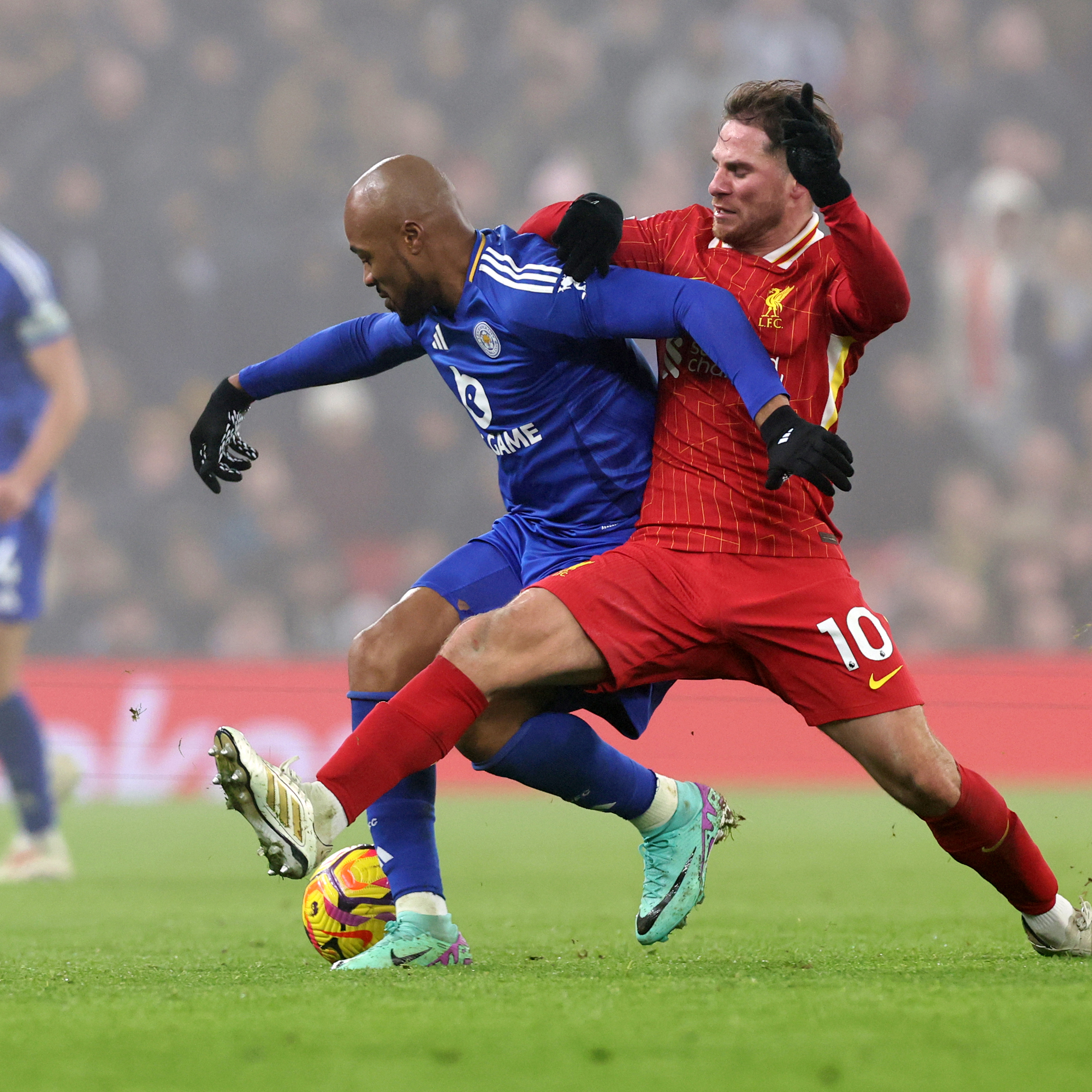 Jordan Ayew tussles for the ball against Liverpool.