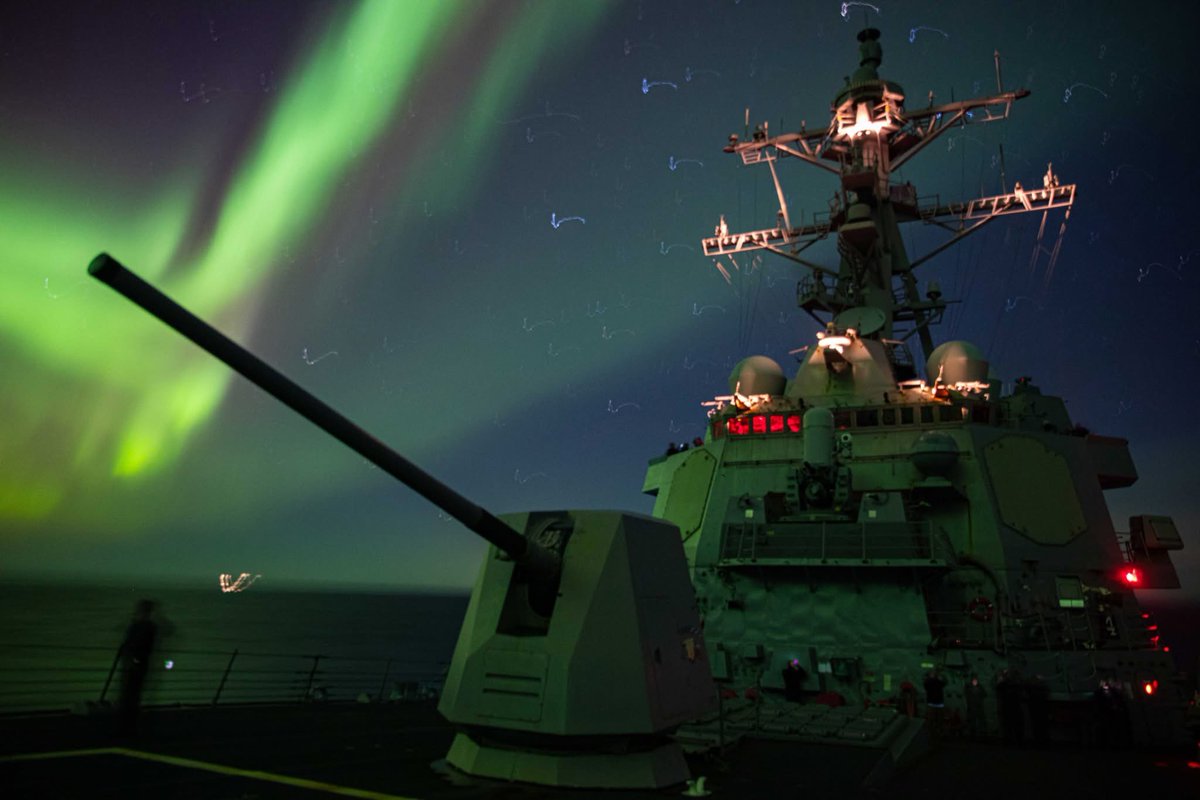 USNavyEurope's tweet photo. #FlashbackFriday USS Paul Ignatius (DDG 117) sails under the Northern Lights while underway in support of exercise Steadfast Defender 2024, March 2024. https://t.co/C1bLkWbIRJ