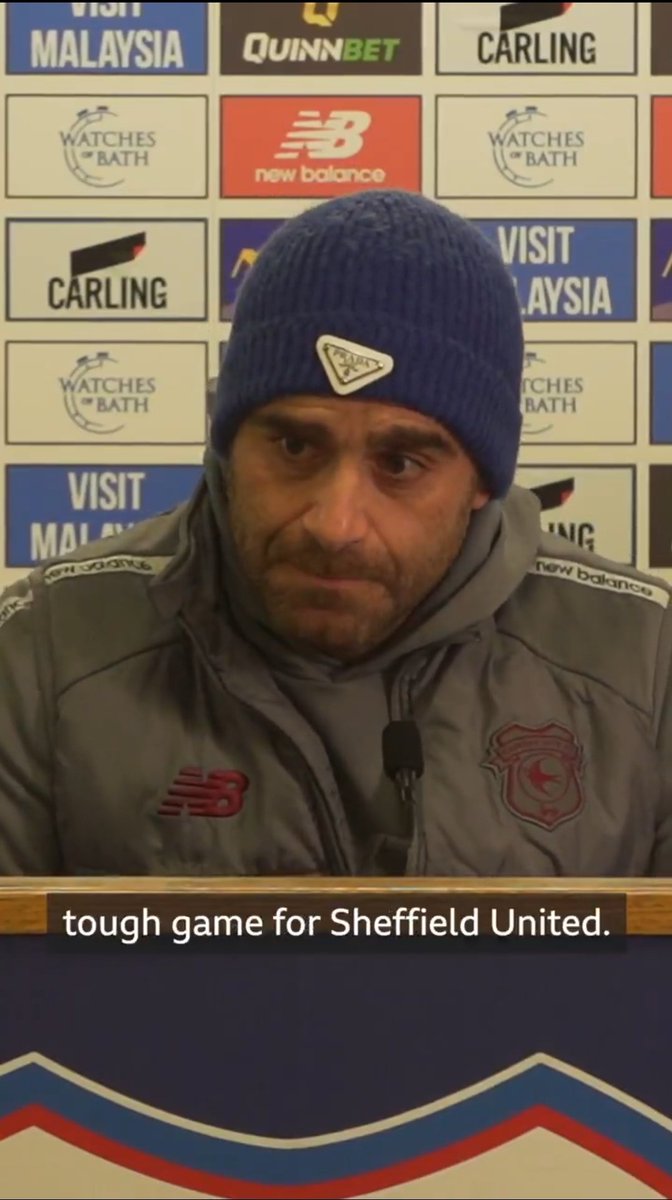 Terrible lighting for a media room.
Wooly hat, hoodie and padded warm coat worn inside. Could even be wearing gloves for all we know.

Screams of cutbacks on utilities.

Preparing for league one early?