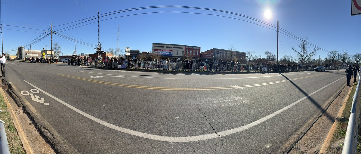 Crowds await their final goodbye to President Jimmy Carter in Plains, Georgia.